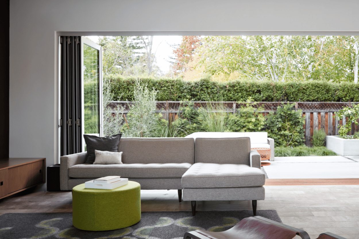 Milgard AX650 bifold movable glass wall opened to a living room